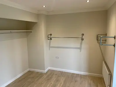 an empty room with a closet with two racks on the wall at Executive home with plenty of room in Ely