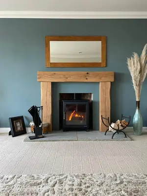 a living room with a fireplace with a blue wall at Executive home with plenty of room in Ely