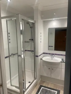a bathroom with a shower and a sink at Executive home with plenty of room in Ely
