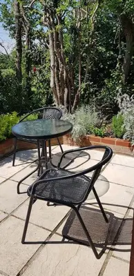 a table and a chair sitting next to a table at Lauriston Stay in Birch