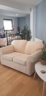 a white couch in a living room with a table at Lauriston Stay in Birch