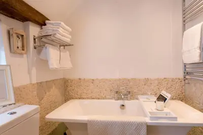 a bathroom with a sink and a bath tub at Miller Cottage a luxury 1550's cottage in the Historic centre of Saffron Walden in Saffron Walden
