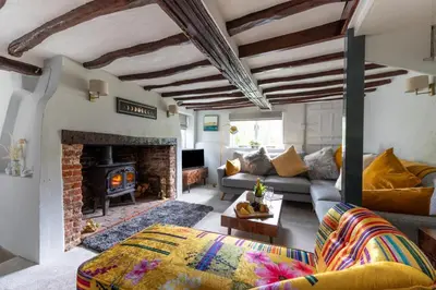 a living room with a couch and a fireplace at 3 Bed in Letheringham oc-pclet in Kettleburgh