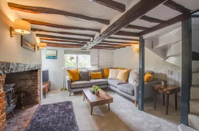 a living room with a couch and a fireplace at 3 Bed in Letheringham oc-pclet in Kettleburgh