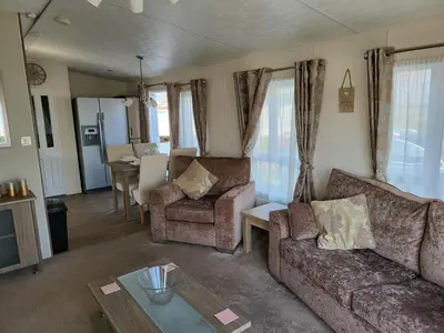 a living room with a couch and chairs and a table at 2BR-Sleeps6-Fireplace-Parking-Patio-Seaside in Clacton-on-Sea