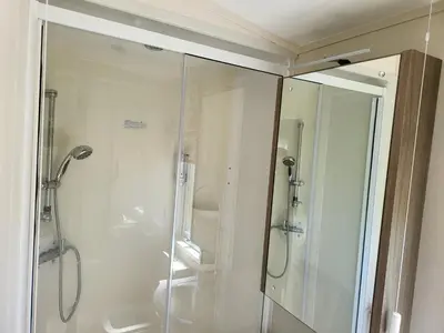 a bathroom with a shower and a glass shower stall at 2BR-Sleeps6-Fireplace-Parking-Patio-Seaside in Clacton-on-Sea