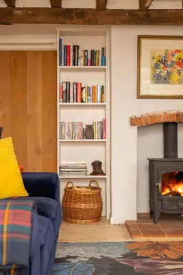 a living room with a couch and a fireplace at 4 Bed in Westleton oc-holc in Westleton