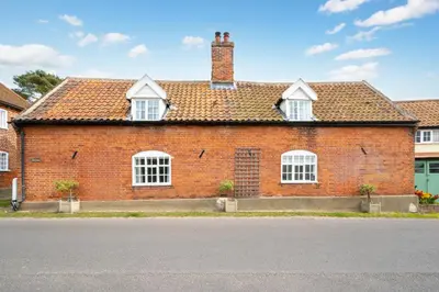 a red brick house with white windows on a street at 4 Bed in Westleton oc-holc in Westleton
