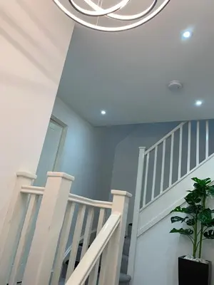 a white staircase with a potted plant at A BYK luxury modern home that sleeps 2 - 8 people in Horndon on the Hill