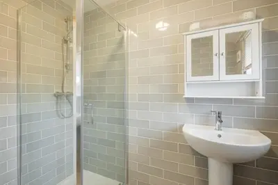 a bathroom with a sink and a shower at Beautiful and Spacious Cambridge Home with Free Parking & Garden! in Cambridge