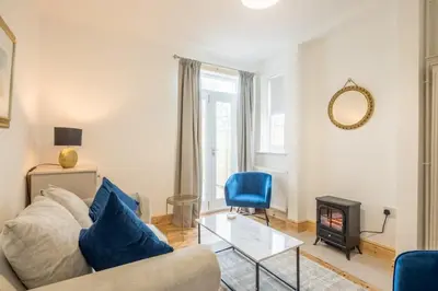 a living room with a couch and a fire place at Beautiful and Spacious Cambridge Home with Free Parking & Garden! in Cambridge