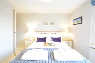 a bedroom with a bed with two white pillows at 6 Coastguard Cottages, Aldeburgh in Aldeburgh