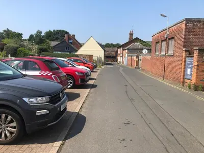 a row of parked cars parked on the side of a street at Elizabeth Clark in Manningtree