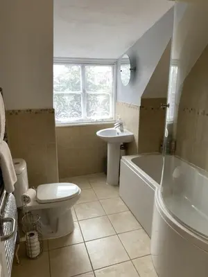 a bathroom with a toilet and a tub and a sink at Elizabeth Clark in Manningtree