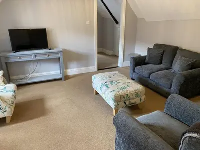 a living room with two couches and a tv at Elizabeth Clark in Manningtree