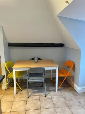 a table and chairs in a room with an attic at Elizabeth Clark in Manningtree
