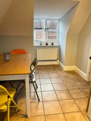 a dining room with a table and chairs and a window at Elizabeth Clark in Manningtree