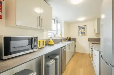 a kitchen with white cabinets and a microwave at Fabulous Large Apartment for 7 - CENTRAL Cambridge in Cambridge