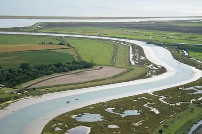 an aerial view of a river and fields at The Coach House Barn - Valley Farm in Sudbourne