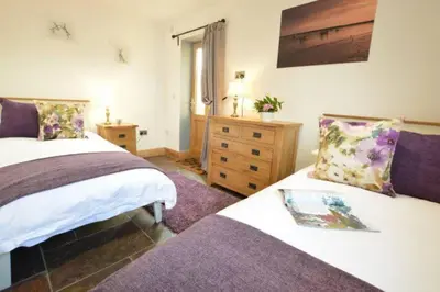 a bedroom with two beds and a dresser at The Knox - Beautiful Two Bed Cottage Near Orford in Woodbridge