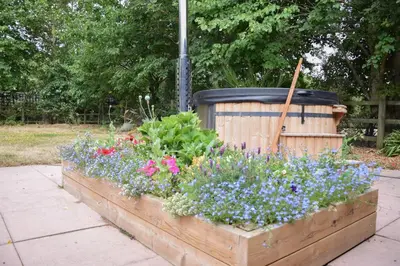 a garden with flowers in a wooden box at The Piglets in Woodbridge