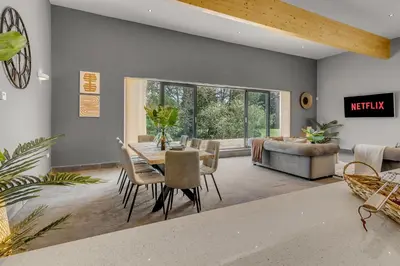 a living room with a table and chairs and a couch at 4 Bedroom House in Larling, near Thetford in Snetterton