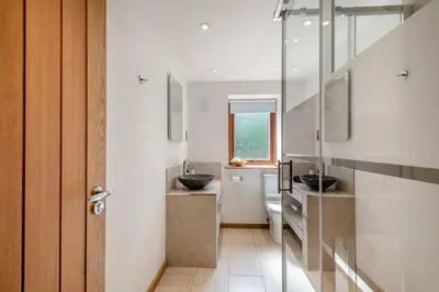 a bathroom with two sinks and a mirror at 3 Bed in Ketteringham oc-1878 in East Carleton
