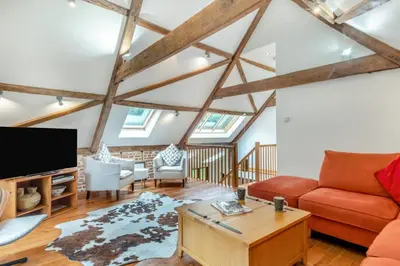 a living room with a red couch and a tv at 3 Bed in Ketteringham oc-1878 in East Carleton