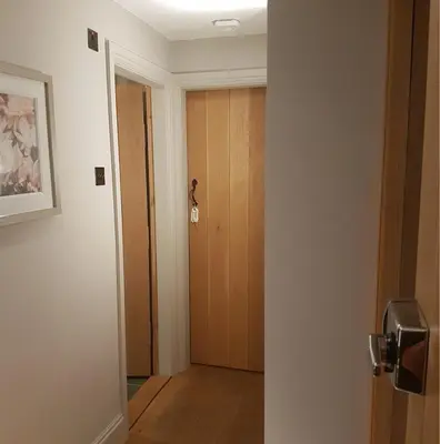 an empty room with a door and a hallway at Glanthams Lodge Guestroom in Shenfield