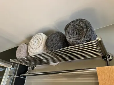 a metal rack with towels on top of an oven at Glanthams Lodge Guestroom in Shenfield