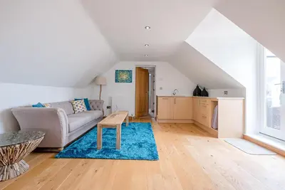 a living room with a couch and a table at Guild House, Aldeburgh in Aldeburgh