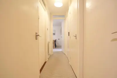 a hallway with white walls and a long hallway with white floors at Pass the Keys 1BR Modern Beautiful House Pass the Keys in Cambridge
