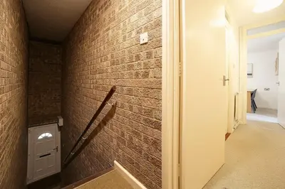 a brick wall in a room with a hallway at Pass the Keys 1BR Modern Beautiful House Pass the Keys in Cambridge