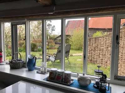 a kitchen window with views of a yard at Simpers Drift, Great Glemham in Saxmundham