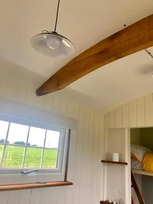 a room with a window and a light fixture at Cranfield Retreat & Glamping in Long Melford