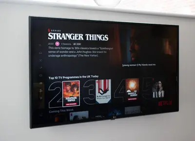 a television screen with a bunch of movies on it at 121 Studio - Apartment with Kitchen, Terrace, Stansted Airport Shuttle in Bishops Stortford