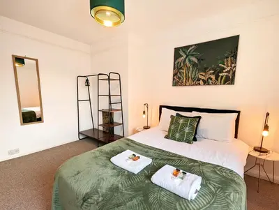 a bedroom with a bed with two towels on it at CENTRAL CAMBRIDGE, CHARMING 3-Bed HOUSE WITH FREE PARKING! in Cambridge