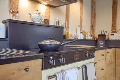 a kitchen with a stove with a pan on it at Halcyon Barn, Wissett in Wissett