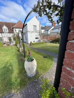a vase with a plant in it in a yard at Blythe Cottage in Long Melford