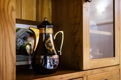 a black and gold jug sitting on a wooden cabinet at Spacious Cabin EVCharger and free Parking near Cambridge in Cambridge
