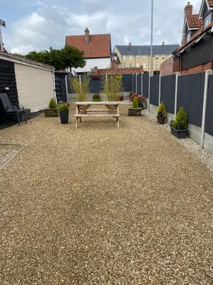 a patio with a wooden bench and a fence at Self-contained, Framlingham Snug, Private Parking, no cooking facilities in Framlingham