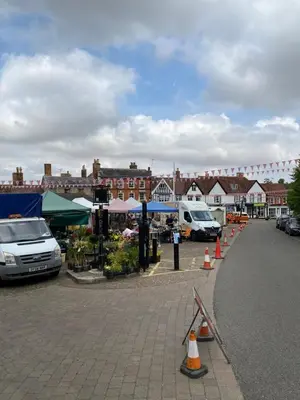 a parking lot with a market with cars and tents at Self-contained, Framlingham Snug, Private Parking, no cooking facilities in Framlingham