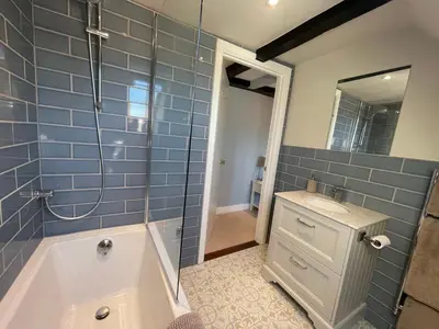 a bathroom with a tub and a sink and a shower at Cathedral View Apartment, Flat 4 in Bury Saint Edmunds