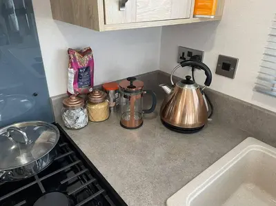 a kitchen counter top with a tea kettle on it at Mersea Villa in West Mersea