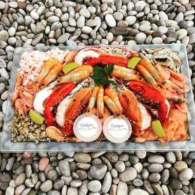 a tray of different types of seafood on a table at Mersea Villa in West Mersea