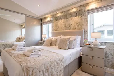a bedroom with a large bed with towels on it at Marshwiggle, Aldeburgh in Aldeburgh