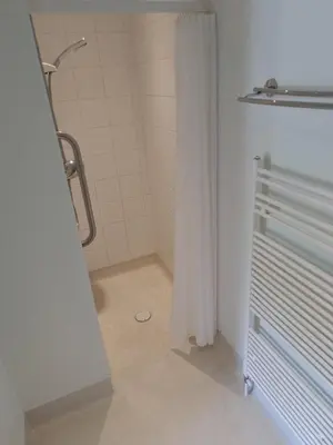 a bathroom with a shower with a shower curtain at The Courthouse Inn in Colchester