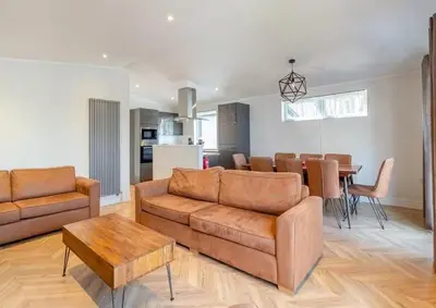 a living room with a couch and a table at Woolverstone Marina and Lodge Park in Ipswich