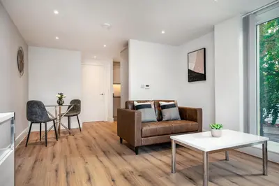a living room with a couch and a table at Citystay Living - Dutch's Corner in Cambridge
