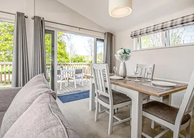 a living room with a table and chairs and a dining room at Hawthorn Glen Lodges in Downham Market